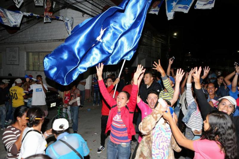 Anhänger des amtierenden Präsidenten von Honduras feiern auf der Straße, nachdem er sich zum Wahlsieger erklärt hatte