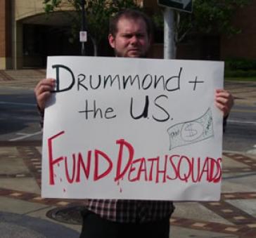 Protest in Vereinigten Staaten: "Drummond und die USA finanzieren Todesschwadrone" Demonstrant in den USA mit Plakat gegen Drummond